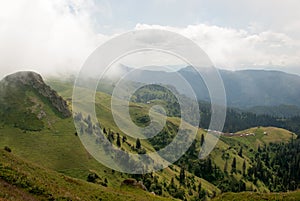 View of the valley with small houses and paths far below