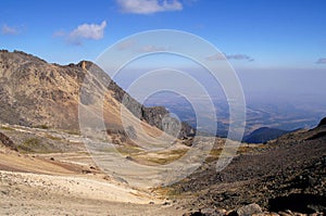 View of valley and smog from volcan Popocatepetl eruption from volcan Iztaccihuatl photo