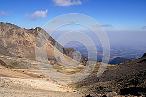 View of valley and smog from volcan Popocatepetl eruption from volcan Iztaccihuatl photo