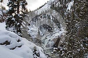 View of valley and snow covered waterfall in Yellowstone National Park