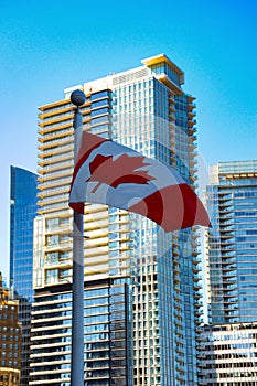 A view of Vancouver\'s downtown from the docks overlooking Vancouver Harbor, with the Canadian Flag at the forefront.