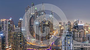 View of various skyscrapers in tallest recidential block in Dubai Marina aerial day to night timelapse