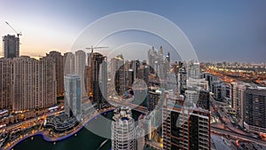 View of various skyscrapers in tallest recidential block in Dubai Marina aerial day to night timelapse