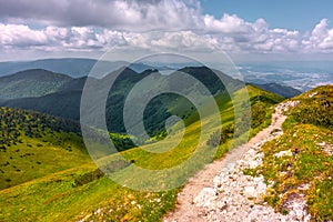 View of the vast mountains in Mala Fatra National Park, Slovakia, on a hot day of summer with cloudy sky. Summer hiking