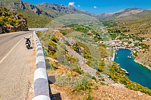 View on Vathi bay, lowland and scooter standing on the roadside