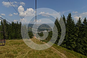 View of Vatra Dornei city, Romania, in descent with the chairlift