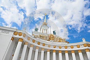 View on VDNKh central pavilion. USSR Empire style white building with traditional soviet golden elements, columns