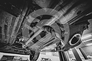 View of the vehicle from below. Cardan shaft. Malfunction and problem. Torque transmission to all four wheels. Car service. SUV.