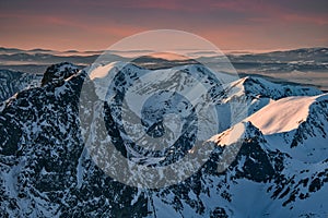 View of Velky Mengusovsky stit peak from peak of Rysy in High Tatras during winter evening photo