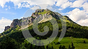 View of Velky Rozsutec, Mala Fatra during sunset. Prominent rock mountain with green mea