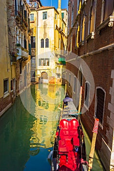 View of Venice narrow canal with old buildings and gondola Italy