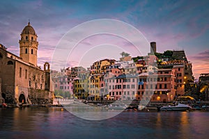 View of Vernazza one of Cinque Terre in the province of La Spezia, Italy, happy young couple picnic in the mountain with