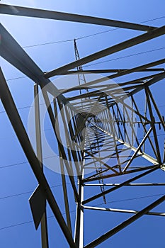 View of very large electricity pylons with high voltage cables from a moving car