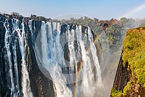 View on the victoria falls from zambia in high water season wit ablue sky in africa