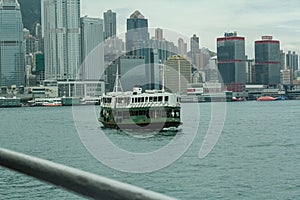 The view of Victoria Harbour, Hong Kong from the coast with a ferry.