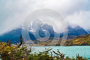 View of View of Cuernos del Paine covered with fog and lake Pehoe