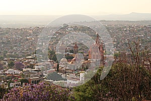 View from a view point mirador onto the famous church cathedral Parroquia de San Miguel Arcangel, emblem of San Miguel de Allende photo