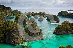 View from the top of the cliff at remote archipelago Pulau Wayag, Raja Ampat, Indonesia photo