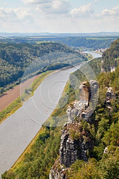 View from the viewpoint Saxon Switzerland over the Elbe valley with a beautiful sandstone rock formation in the foreground