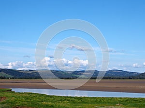 View of the village of arnside from the bank of the river kent with surrounding countryside