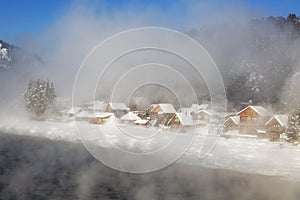 View of the village of Artybash through heavy fog over the Biya River in winter. Altai Republic,
