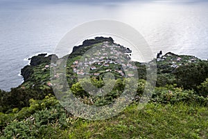 View on the village of FajÃ£ do Ouvidor, a permanent debris field, built from the collapsing cliffs on the northern coast of the