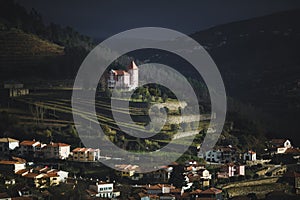 View of a village in the hills of the Douro Valley at dusk, Portugal. photo