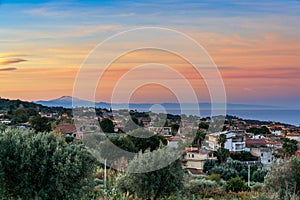 view of the village of Ricadi in Calabria at sunrise with Sicily and Mount Etna in the background photo