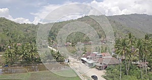 View of village in a valley with nice field view under the mountains with following the black car