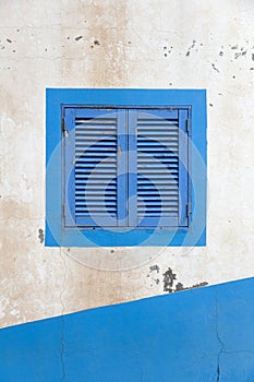 Vintage blue window shutter on the old house