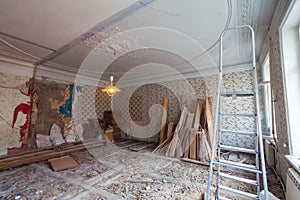 View the vintage room with fretwork on the ceiling of the apartment during under renovation, remodeling and construction.