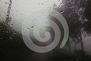 View of violent storm with heavy rainfall through the windshield of car