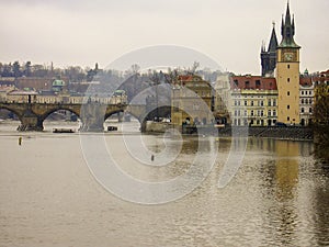 View of the Vltava River and the built up banks and Old Town Bridge Tower and famous Charles Bridge in Prague capital of the Czech