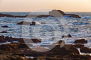 View of the volcanic shore of the Atlantic Ocean in the area of the city of Essaouira in Morocco on a summer evening