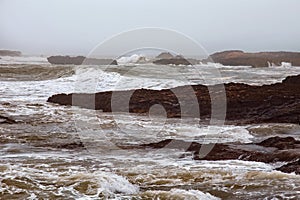 View of the volcanic shore of the stormy Atlantic Ocean in the area of Essaouira in Morocco