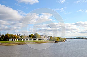 View of the Volkhov River, the city behind the river and the old Gostiny Dvor on a sunny autumn day. Veliky Novgorod, Russia