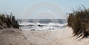 View of walking down the beach with a rough Atlantic Ocean