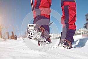 View of walking on snow with Snow shoes and Shoe spikes in winter.