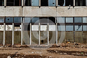 View of a wall with the broken windows and lattices. Front.