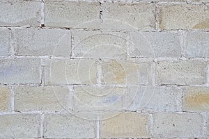 The view of the wall is made up of large gray concrete blocks.