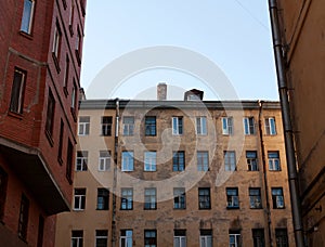 View of wall with windows in courtyard an old house