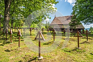 View at the War memorial cemetery with Wooden Church of Saint Michael Archangel in village Topola, Slovakia