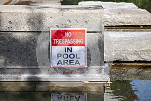 View of warning sign No trespassing in pool area