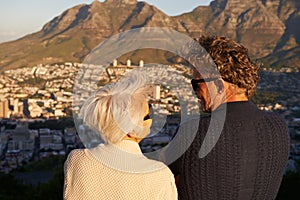 This view was worth the walk. View of a senior couple standing on a hillside together.