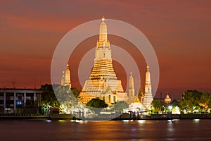 View of the Wat Arun temple, night illumination at sunset. Bangkok, Thailand