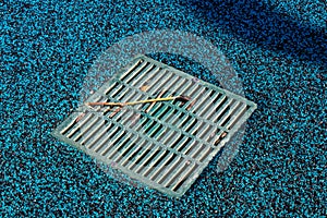 View of water drain on water park playground which turns blue because of low quality of rubber cover made from fine virgin EPDM