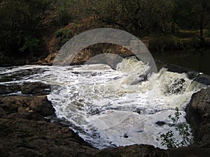 WATER CASCADING OVER A WEIR IN A RIVER