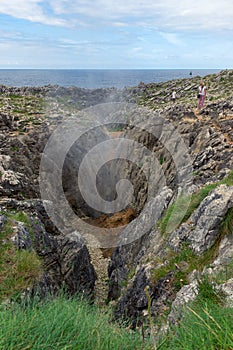 View of water shooting up through a hole at the jesters of Arenillas in Asturias, Spain