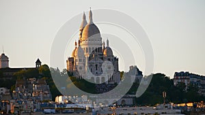 View of the water tower and the Sacré-Coeur basilica at sunset on the Butte Montmartre in Paris