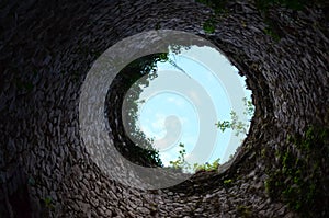 View from the water well from bottom up. The stone walls of the